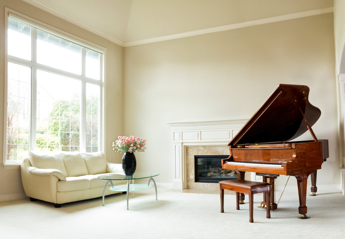 brown piano and white sofa