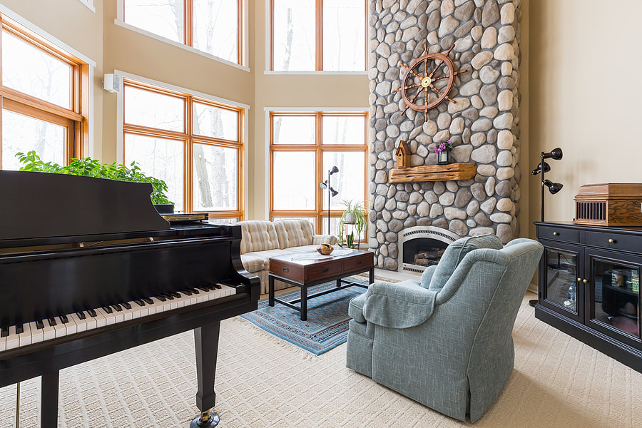 living room with black piano
